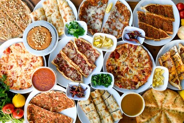 Delicious meat kebab with fresh vegetable salad served with variety of Turkish dishes and appetizers. Top view of assorted Turkish food and meze, tasty and healthy Mediterranean cuisine.