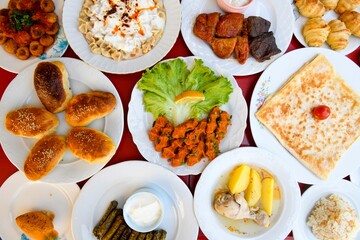 Traditional Turkish cuisine. Pizza, pita, pidesi, sucuk, hummus, kebab. Many dishes on the table. Serving dishes in restaurant. Background image. Top view, flat lay