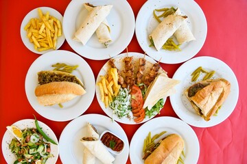 Delicious meat kebab with fresh vegetable salad served with variety of Turkish dishes and appetizers. Top view of assorted Turkish food and meze, tasty and healthy Mediterranean cuisine.