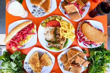 Delicious meat kebab with fresh vegetable salad served with variety of Turkish dishes and appetizers. Top view of assorted Turkish food and meze, tasty and healthy Mediterranean cuisine.
