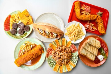 Traditional Turkish cuisine. Pizza, pita, pidesi, sucuk, hummus, kebab. Many dishes on the table. Serving dishes in restaurant. Background image. Top view, flat lay