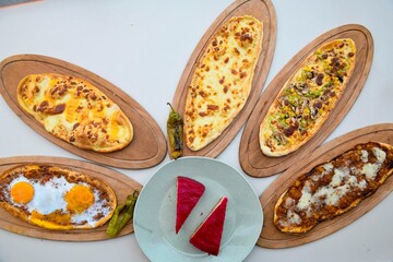 Delicious meat kebab with fresh vegetable salad served with variety of Turkish dishes and appetizers. Top view of assorted Turkish food and meze, tasty and healthy Mediterranean cuisine.