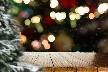 Fototapeta na wymiar Blurred Christmas background with empty wooden table in focus. Empty display for product assembly