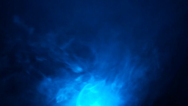Smoke under color light in the dark. spreading steam. abstract foggy background