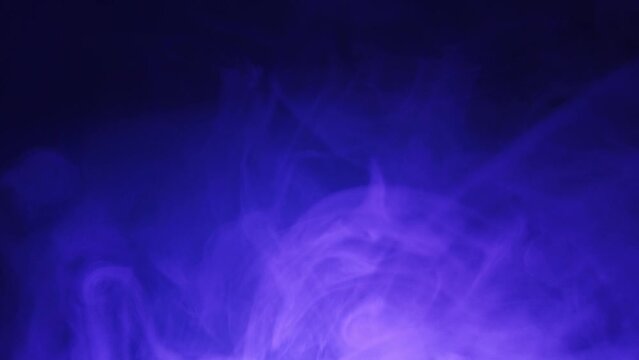 Smoke under color light in the dark. spreading steam. abstract foggy background