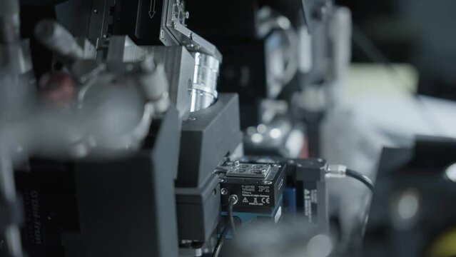 Sample being placed into powerful microscope closeup