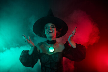 Photo of creepy fear lady warlock doing devil ritual enchantment isolated on mystic effect fog...