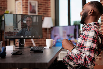 Young adult using online videocall meeting with employees on computer, talking on remote...