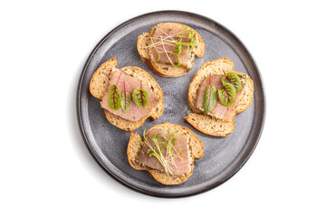 Bread sandwiches with jerky salted meat, sorrel and cilantro microgreen isolated on white. top view.