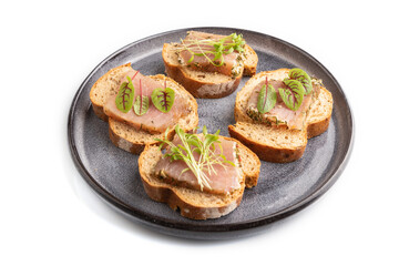 Bread sandwiches with jerky salted meat, sorrel and cilantro microgreen isolated on white. side view.