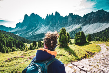 Athletic woman enjoys view from beautiful hike trail at Seceda in the dolomites at noon. Seceda,...