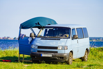 Camper van camping on sea shore