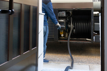 company  truck parked  front a house with hose in door for delivering home heating oil  for boilers - 535355678