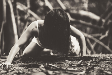 Girl in a white dress in the forest. Zombie. Happy Halloween. All Saints Day. Grainy photo. Soft focus