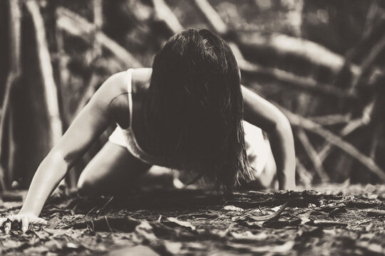 Girl in a white dress in the forest. Zombie. Happy Halloween. All Saints Day. Grainy photo. Soft focus