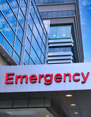 Sign in red letters above hospital emergency entrance - 535356893
