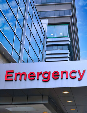 Sign in red letters above hospital emergency entrance