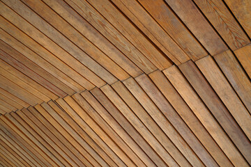 Orange and brown wooden wall with cracked paint and cracks, abstract texture background