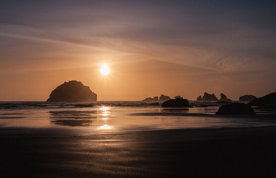 Sunset at Face Rock, in Bandon, Oregon, where the ocean is at low tide