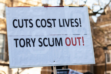CUTS COST LIVES! TORY SCUM OUT! Placard at a Cost of Living protest
