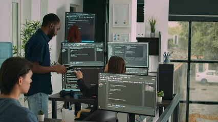 Diverse team of database developers analyzing code on terminal window, working with html script and artificial intelligence. System engineers talking about app developing interface.