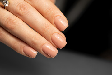 Beautiful nude manicure. Short square nails. Nail design. Manicure with gel polish. Close-up of the...