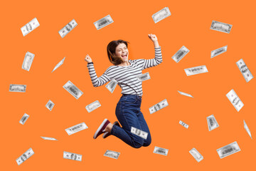 Portrait of satisfied excited woman jumping with clenched fist, celebrating winning lottery, flying...