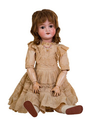 Isolated antique jointed sitting doll a linen dress