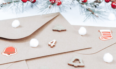 Kraft envelopes with wooden number 4, fir vekti, fluffy snow ball and christmas decoration on a blue background.