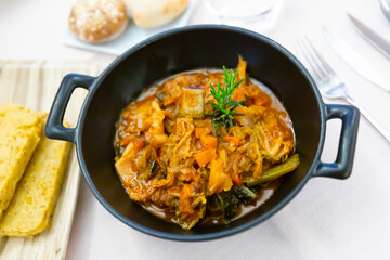 Cassoula with polenta. Meat on the bone with stewed vegetables