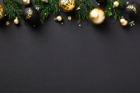Elegant Christmas background with golden balls, decorations, fir branches on black background. Luxury New Year greeting card design, Christmas banner mockup