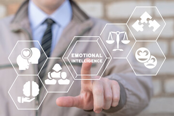 Businessman using virtual touchscreen presses inscription: EMOTIONAL INTELLIGENCE. Emotional...
