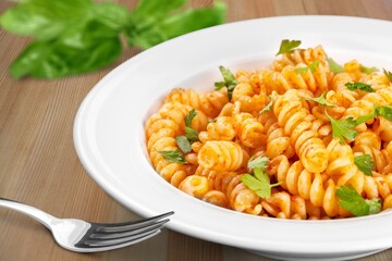 Italian Traditional Dish Pasta a on plate with wooden table background.