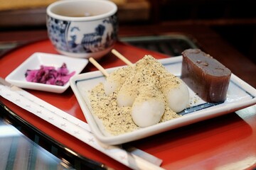 A plate of traditional Japanese sweets — red bean jelly and bean powder-coated dango sticky rice...