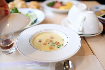 A bowl of cream of chicken and corn soup; part of a typical Japanese-style Western hotel breakfast spread at an airport hotel in Narita, — Chiba Prefecture, Japan