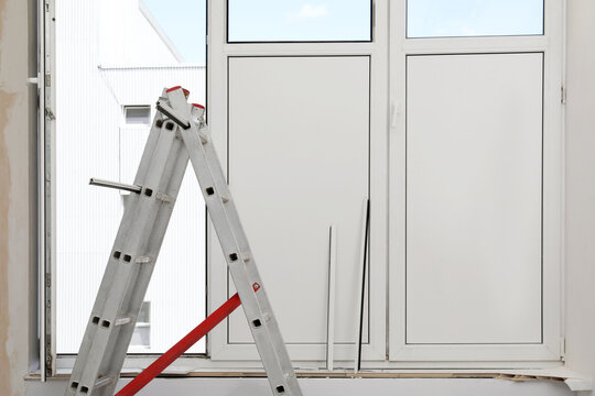 Folding Ladder Near Open Window Indoors. Double Glazing Installation