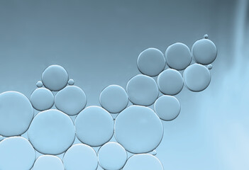 Oil and water bubbles of an art image on blue gradient background. Ideal as app design background,...