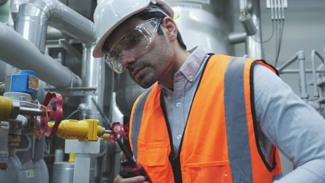 Out of focus with Industrial engineer working and communication for inspect factory and machine standards. Concept of industry, factory, environment and professional people.