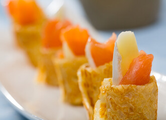 Pancakes rolls with salted salmon on a plate. High quality photo