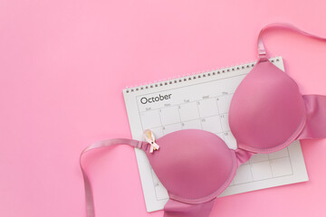 October calendar with pink bra for breast cancer awareness month - obrazy, fototapety, plakaty
