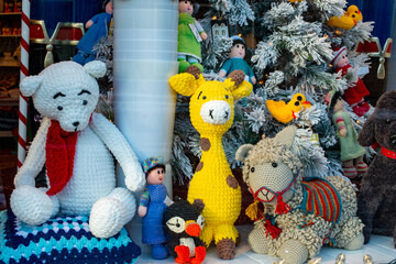 St. John's, Newfoundland, Canada-October 2022: White teddy bear with a red scarf, yellow giraffe,...