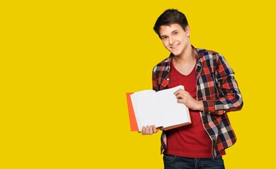 Happy young student standing with a backpack and posing