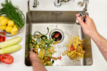 Working kitchen disposer on a modern sink to remove food waste