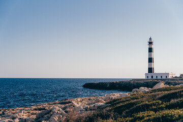 Fototapeta na wymiar Beautiful blue white lighthouse on the Spanish island of Menorca