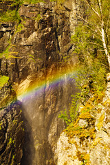 Fototapeta na wymiar Rainbow in rocky mountains