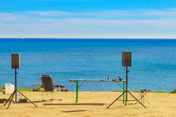 Camp chairs, table and music equipment on beach