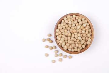 Close-up of chickpeas over bowl and white background with space for lettering