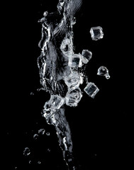 Freeze motion of flying ice cubes with water splash isolated on black background.