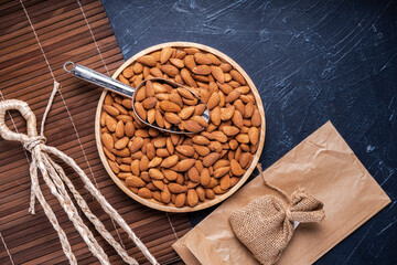 Roasted Delicious Almond on brown wooden table, Almond in wooden plate on wooden table.