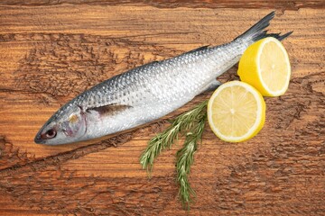 Fresh tasty fish for cooking dish on table with lemon